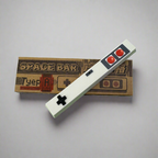 Retro styled spacebar keycap with red and white buttons and a black crosshair on a white background, accompanied by a vintage-themed box with the text 'SPACE BAR' and 'Typewriter'.
