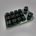 A compact 12-Key Macropad Mechanical Keyboard with a programmable rotary knob, featuring a transparent panel and green keycaps.